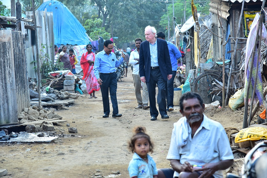 Sobering walk in a grass hut village for a visiting foreigner