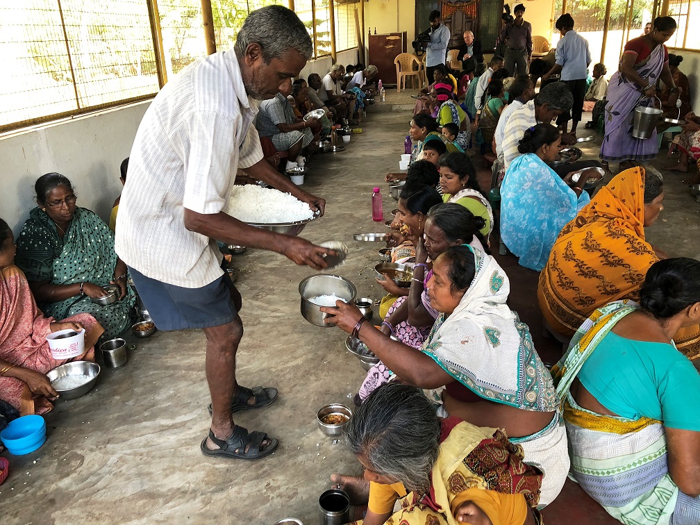 Volunteer workers dispensing food to Lepers